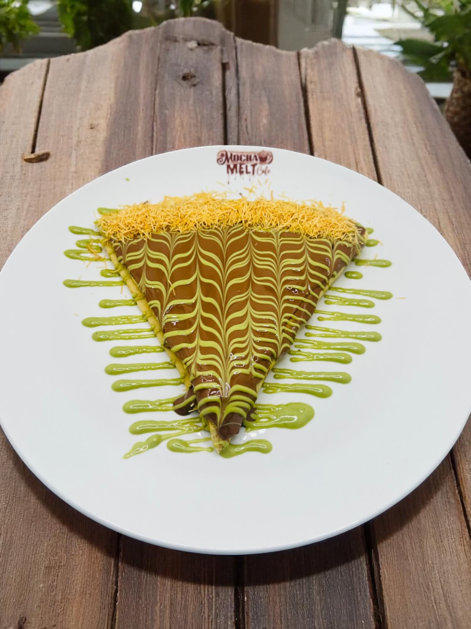 Dubai Crepe topped with chocolate, pistachio drizzle, and crispy kataifi pastry