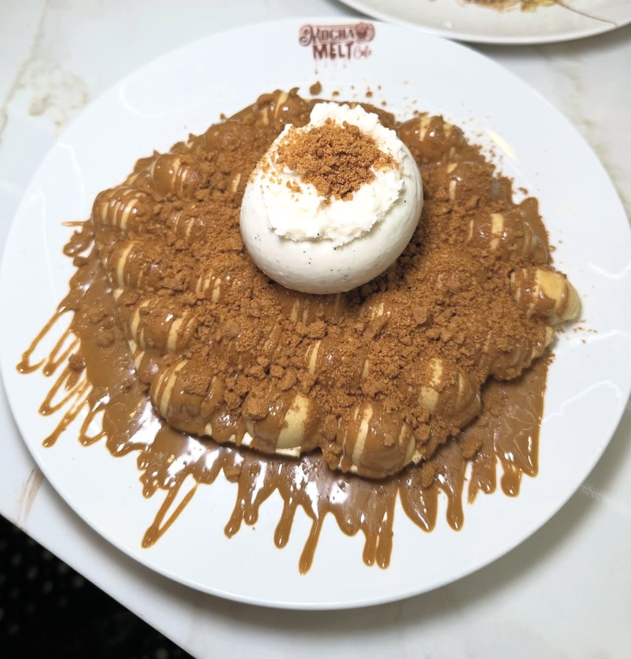 Lotus Bubble Waffle with vanilla gelato, Lotus biscuit crumbs, and Lotus drizzle